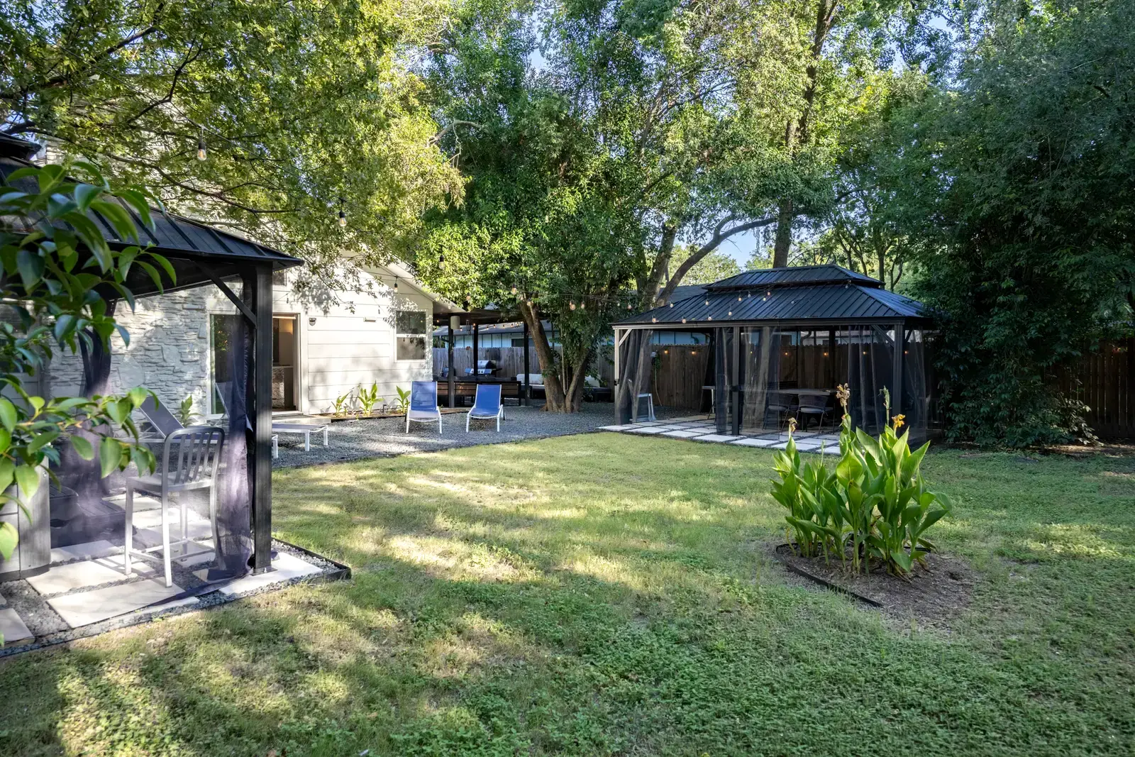 Large tree-shaded fenced backyard at Peppertree Paradise